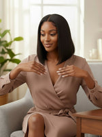 A woman wearing a Unique Style 2 Envy Inc short black bob human hair wig with a natural lace front hairline.